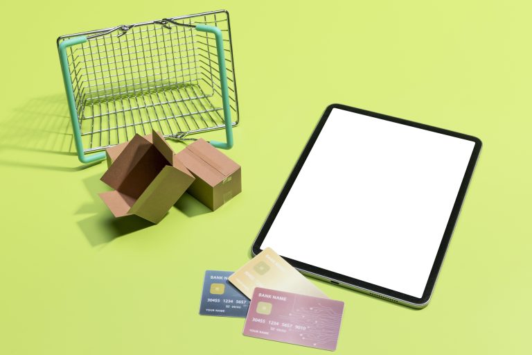 Online shopping items arranged around a payment card and phone