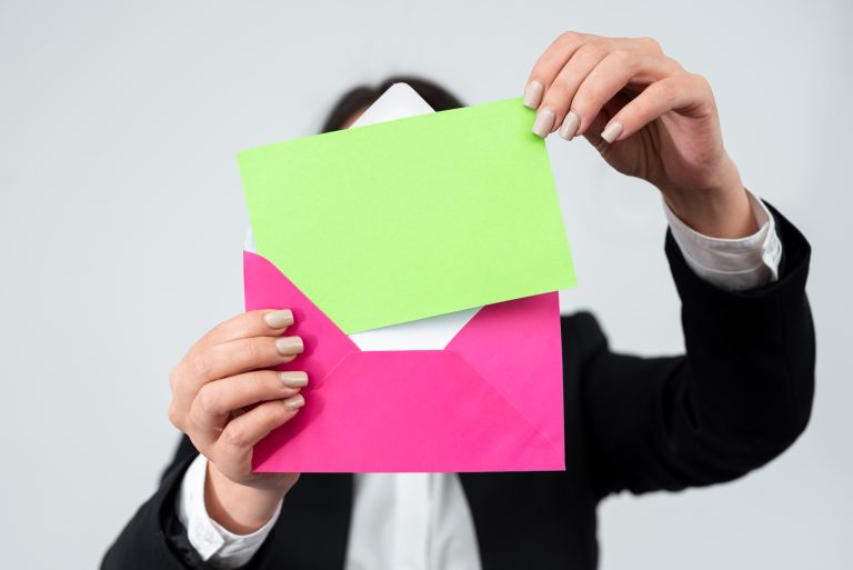 Person placing a letter into an envelope