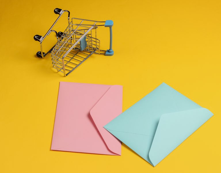 Envelopes and shopping trolley representing ecommerce email campaigns
