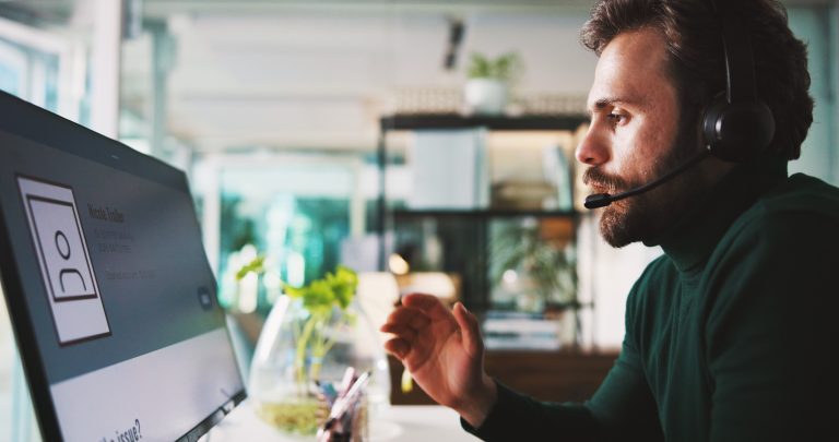 Customer support agent wearing a headset helping website visitors