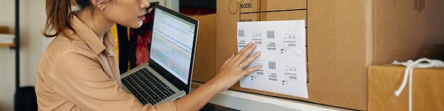 A warehouse worker checking parcel barcodes