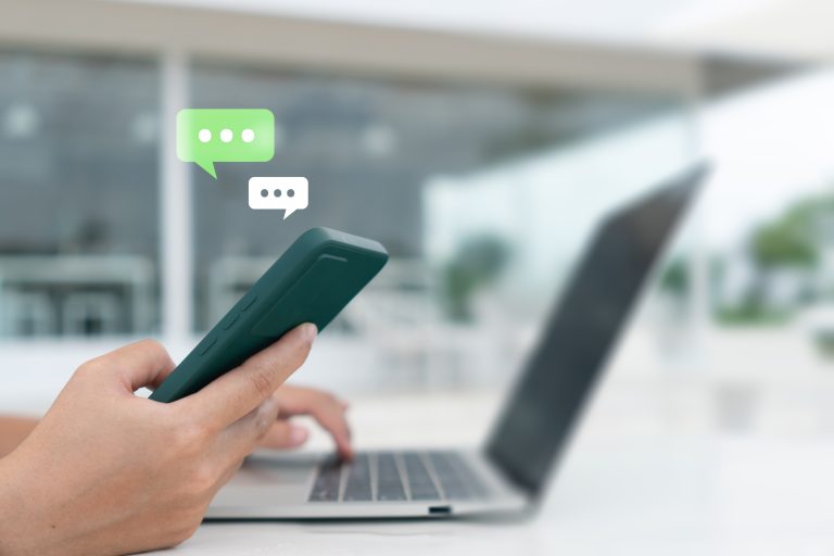 Person using a smartphone with chat and message icons