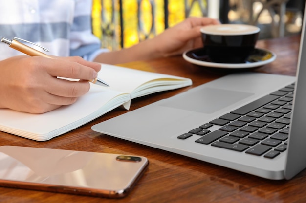 Notebook and laptop used for planning blog content