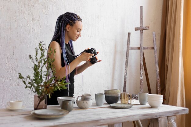 Small business owner photographing handmade products in a studio