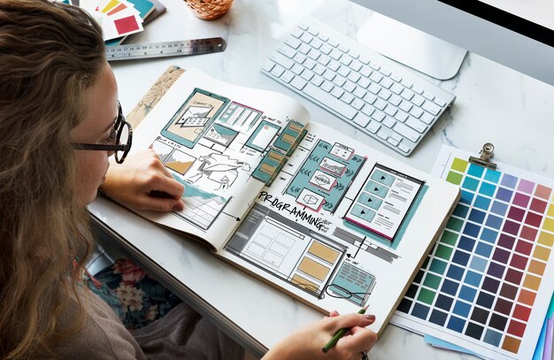 Designer reviewing website layout sketches and colour swatches