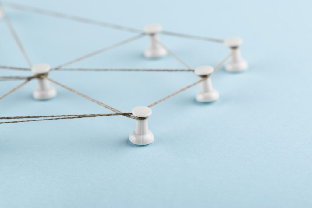 Thread connecting pins to represent link building and relationships