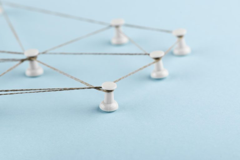 Thread connecting pins to represent link building and relationships