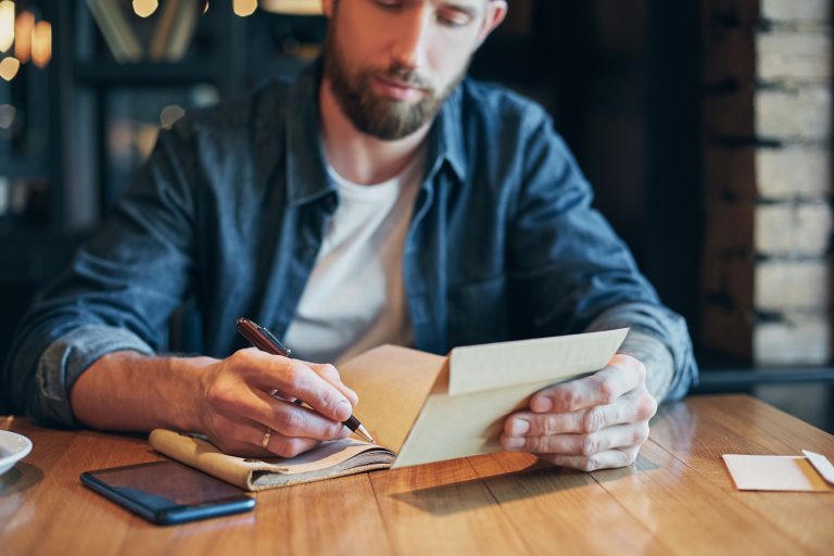 Person writing notes for a content plan