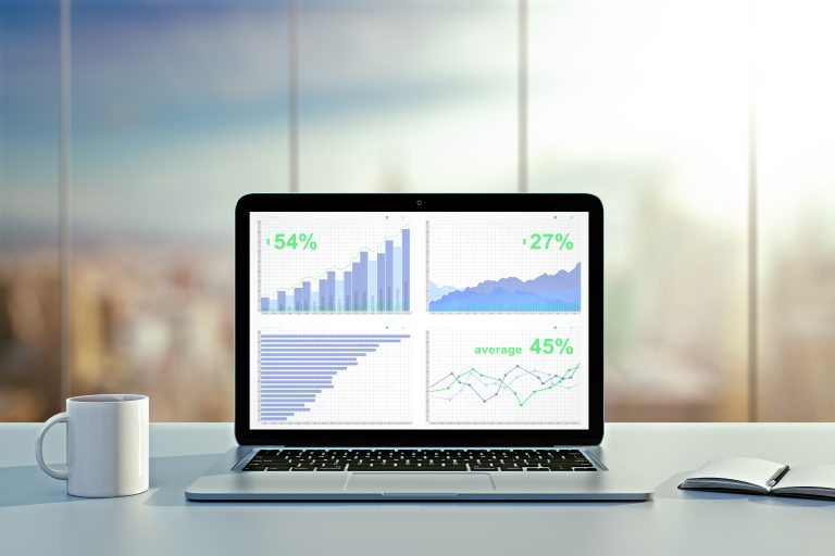 Laptop showing business analytics on a desk