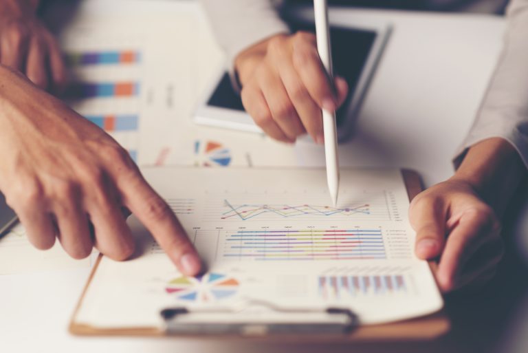 Business people reviewing charts for competitor research