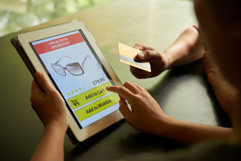 Online shoppers adding a product to a basket on a tablet
