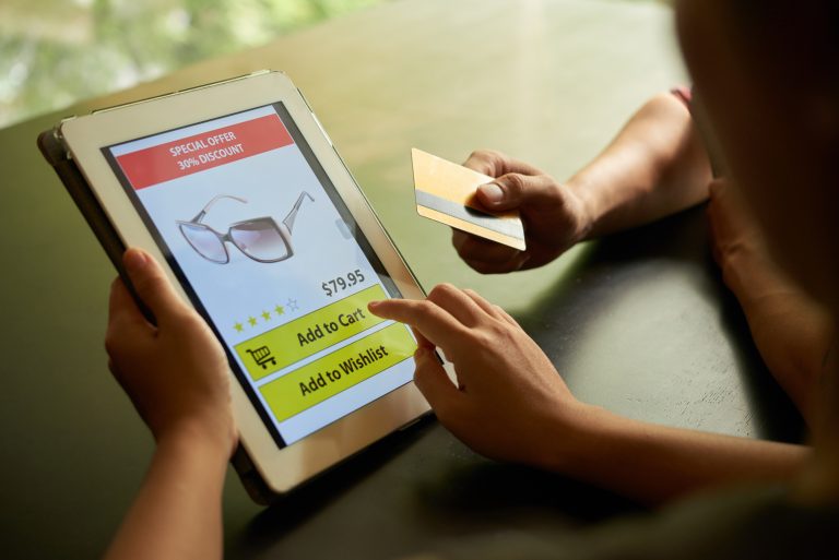 Online shoppers adding a product to a basket on a tablet