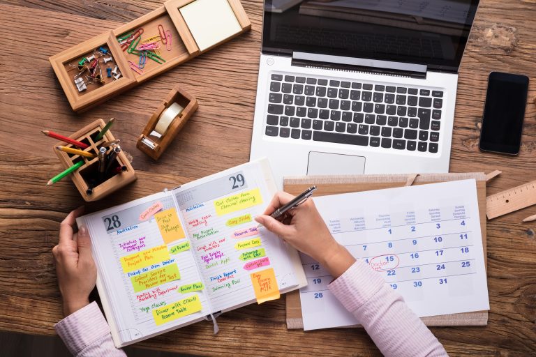 Person planning a content schedule in a diary