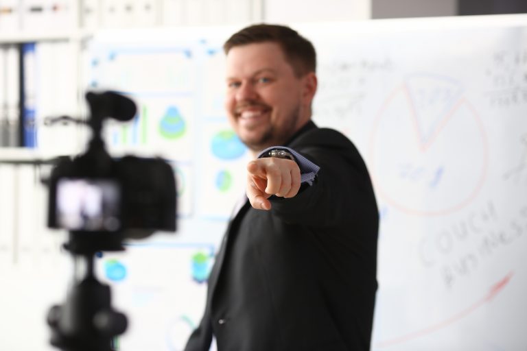 Business presenter recording a video with charts