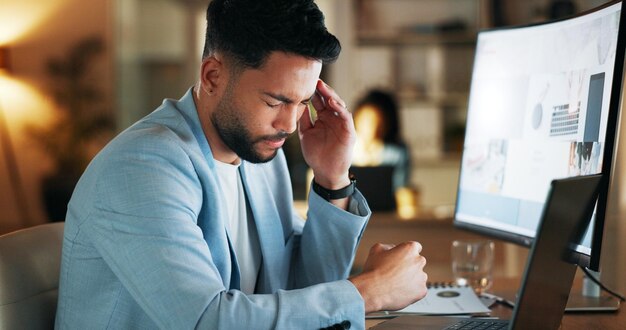 A stressed businessperson working late at a desk