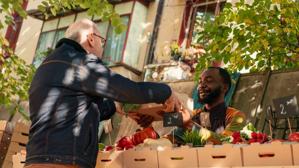 Local business owner selling produce at a market