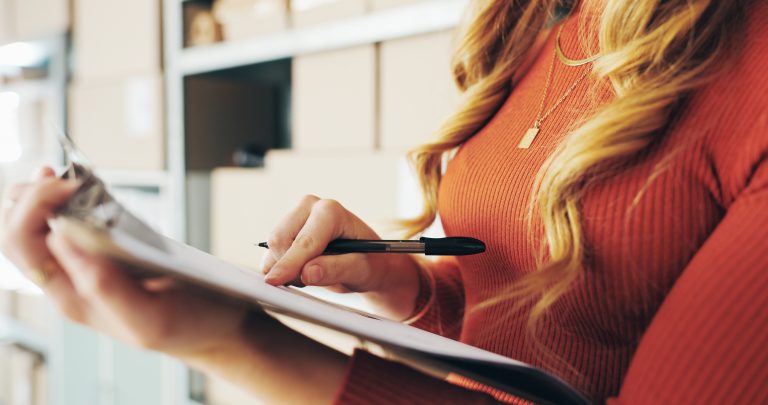 Business owner reviewing documents and packages