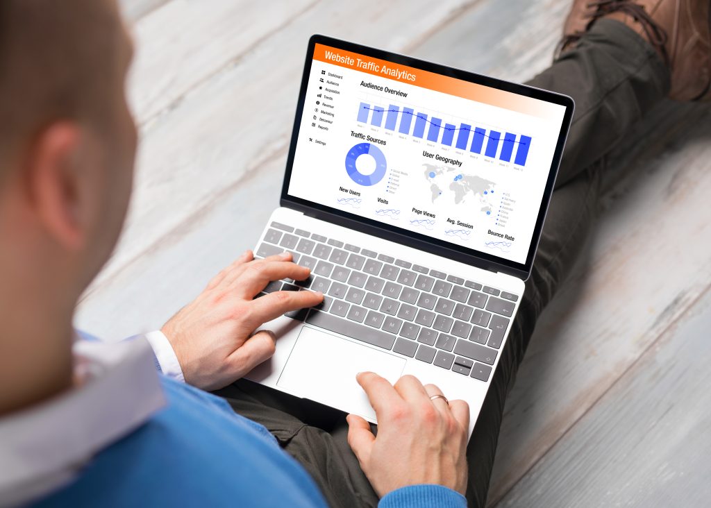 Person reviewing website traffic analytics on a laptop