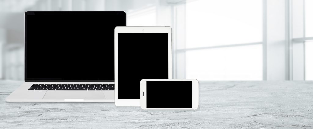 Laptop, tablet, and smartphone showing a responsive website layout