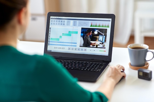 Woman using video editing software on a laptop