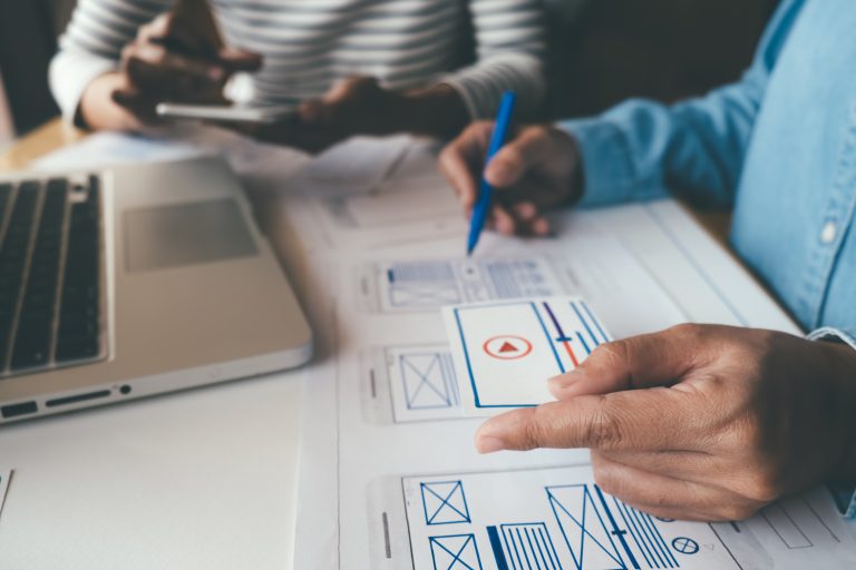 Web designer planning a website layout and mobile experience