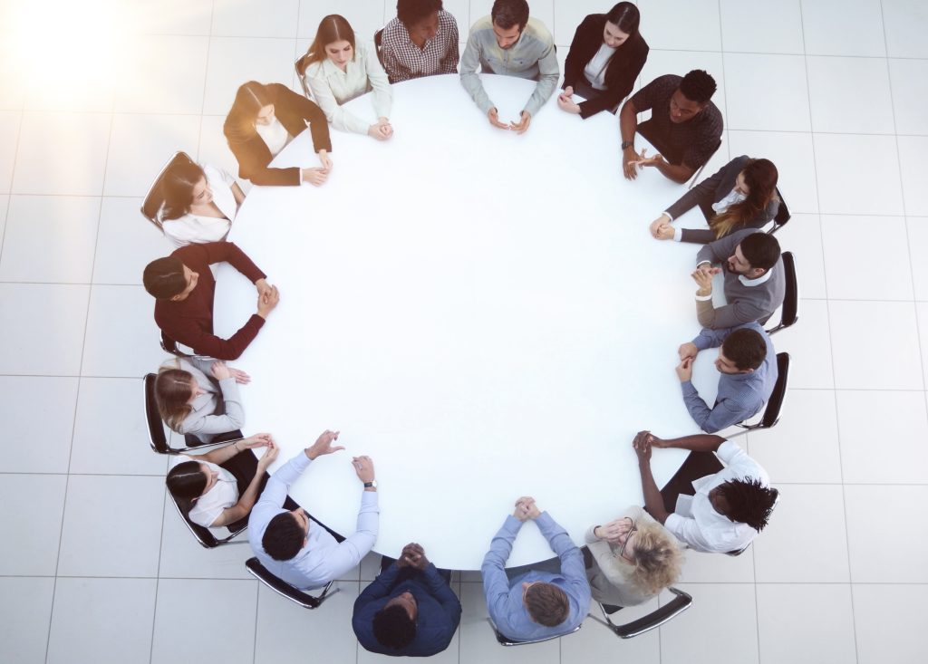 People gathered around a table for a group discussion