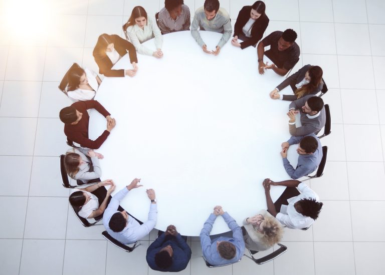 People gathered around a table for a group discussion