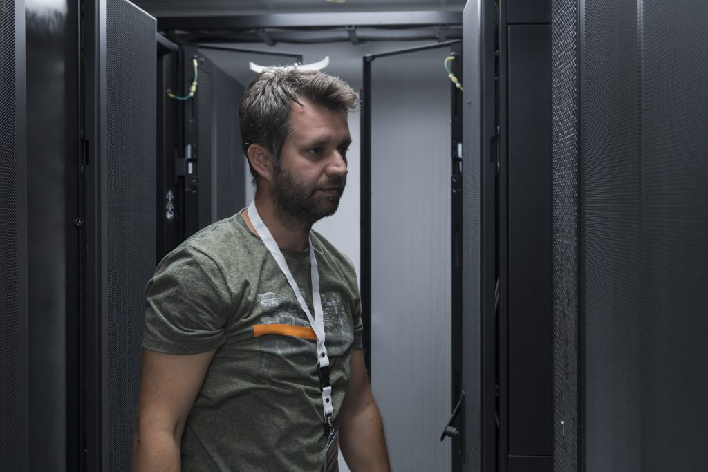 Engineer installing server equipment in a data centre