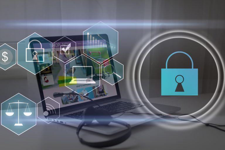 Person using a laptop with a digital cybersecurity shield interface