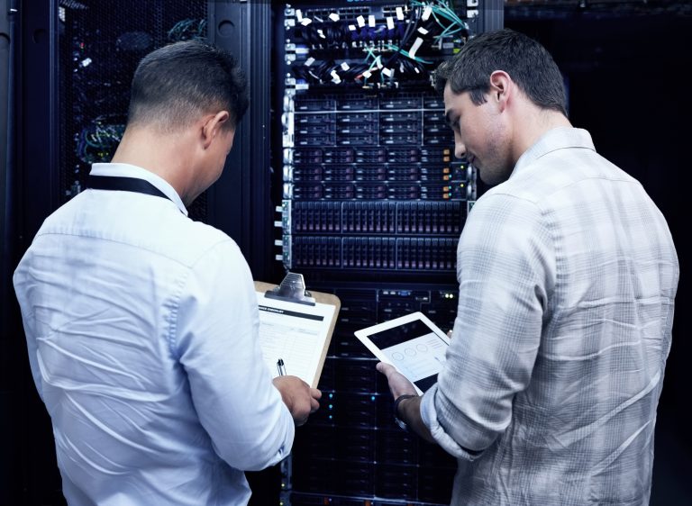 Technical team reviewing server equipment in a data centre