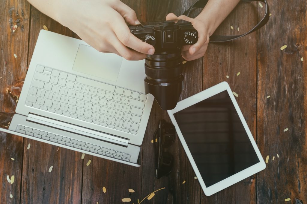 Photographer reviewing images on a camera for website use