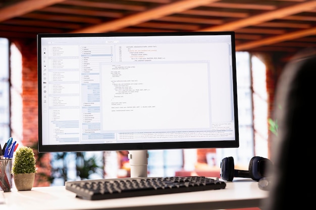 Computer monitor showing website code in a development environment