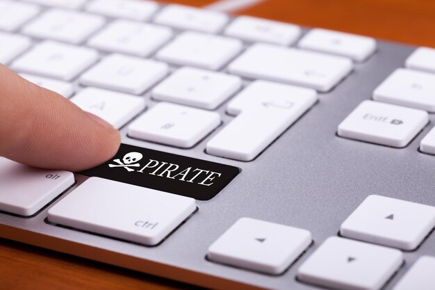 Finger pressing a pirate key on a computer keyboard