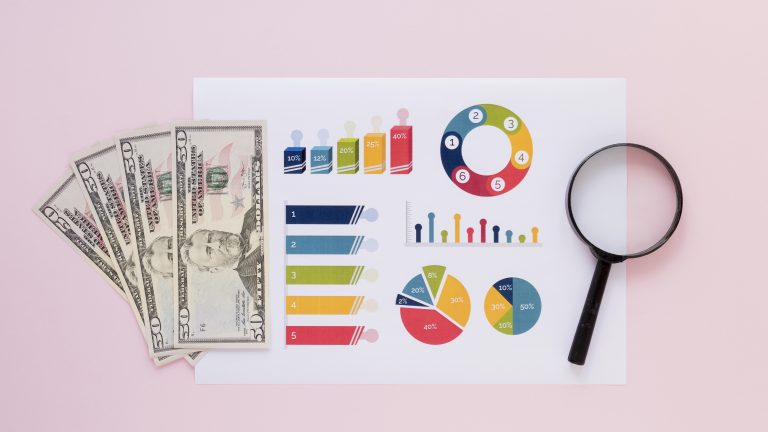 Money and charts representing advertising budget planning