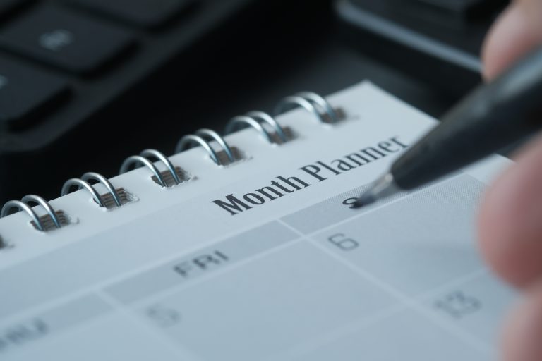 Monthly planner and notepad used for renewal reminders